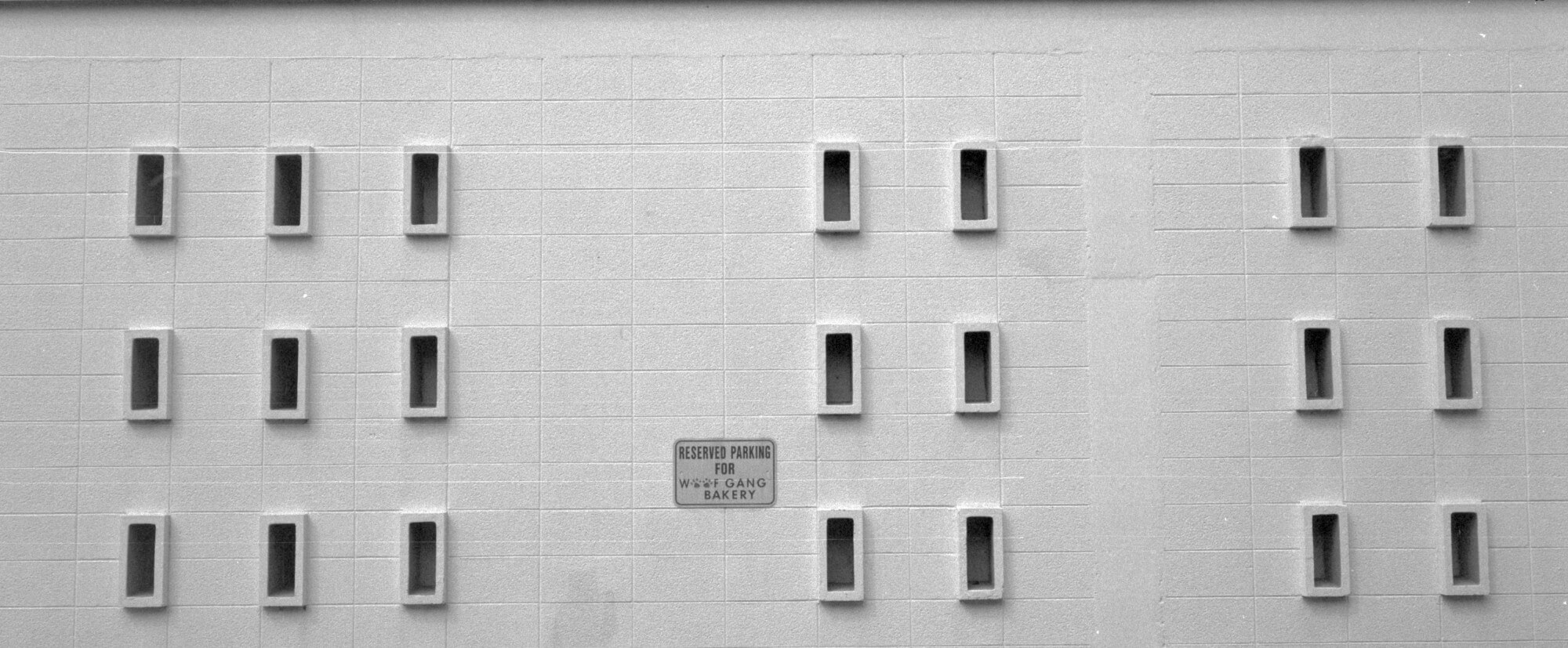 Panorama of the side of the Woof Gang Bakery, showing three groups of small, rectangular windows