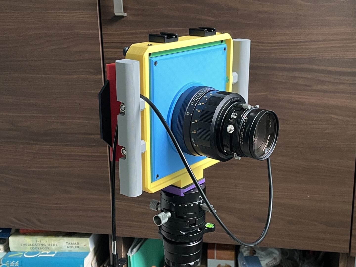 Vega 4x5 rear standard with a custom lens cone and a Mamiya Press 127mm lens attached. Front view.