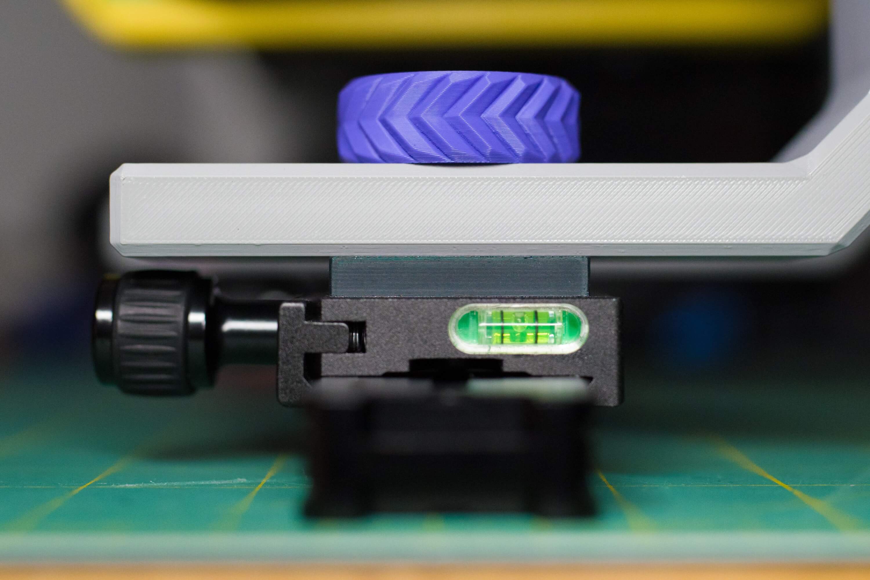 Detail showing (from bottom to top) the arca rail, arca clamp attached to it, spacer, and fork all joined together.